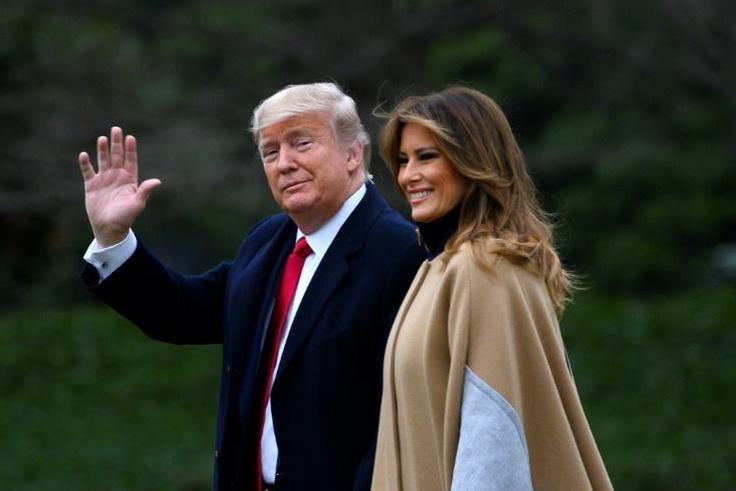 US President Donald Trump waves next to First Lady Melania Trump as they walk to Marine One before departing from the South Lawn of the White House