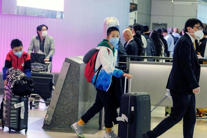 Passengers arrive at LAX from Shanghai, China, after a positive case of the coronavirus was announced in the Orange County suburb of Los Angeles, California, U.S., January 26, 2020.  REUTERS/Ringo Chiu