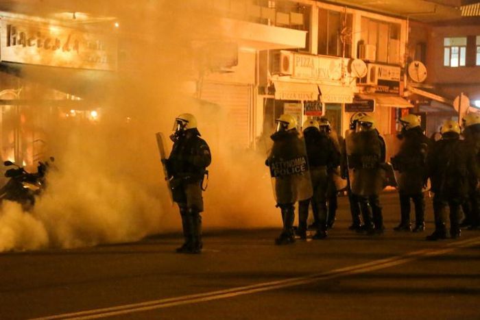 Riot police use tear gas during clashes with demonstrators protesting against the construction of controversial new migrant camps on Lesbos island