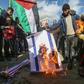 Palestinians angry at controversial peace proposals unveiled by US President Donald Trump burn an Israeli flag during a protest in the Gaza Strip city of Khan Yunis