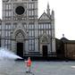 A municipal worker disinfects the Piazza Santa Croce in Florence as part of the measures taken by the Italian government to fight the spread of the COVID-19
