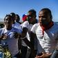 Protestors shout anti-government slogans outside a mass graveyard during the commemorative ceremonies of Haiti's 10th earthquake anniversary on the outskirts of Port-au-Prince, on January 12, 2020