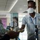 Entebbe airport health workers checked travel documents of passengers arriving on an international flights