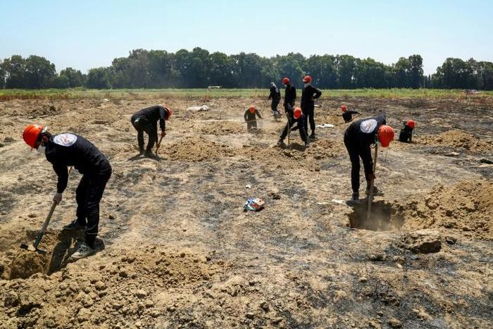 More than 8,000 people last seen in the custody of the Islamic State group remain unaccounted for in Syria despite the exhumation of mass graves, like this one near the jihadists' former stronghold of Raqa