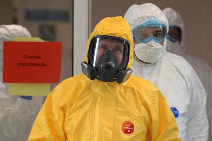 Russian President Vladimir Putin wears protective gear during a visit to a hospital with patients infected with the COVID-19 novel coronavirus