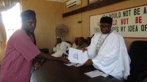 INEC Resident Electoral Commissioner in Kwara, Malam Garba Attahiru-Madami receiving a copy of IPAC document from Prince Adebayo Akadi, IPAC chairman (NAN)