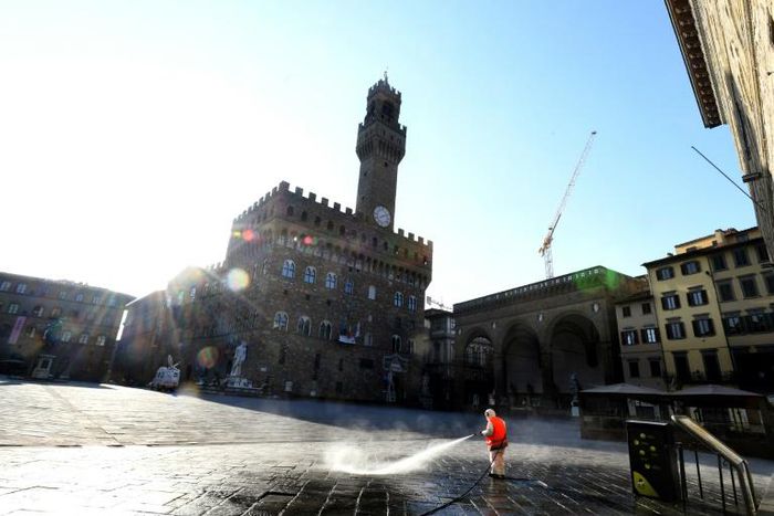 A municipal worker disinfects the Piazza della Signoria, in front of the Palazzo Vecchio, in Florence, on March, 21 2020, as part of measures taken by the Italian government to fight against the spread of the COVID-19 (novel coronavirus).