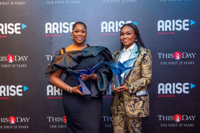 (Left) Miss Folasade Michael-Adenuga, Group Executive Director, Globacom, with the award of 'Entrepreneur of the Decade' won by Dr. Mike Adenuga Jr. and Mrs. Bella Disu, Executive Vice Chairman, Globacom, displaying the 'Brand of the Decade' award won ...