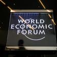 A man walks past a sign of the World Economic Forum (WEF) at the Congress Centre in Davos, eastern Switzerland