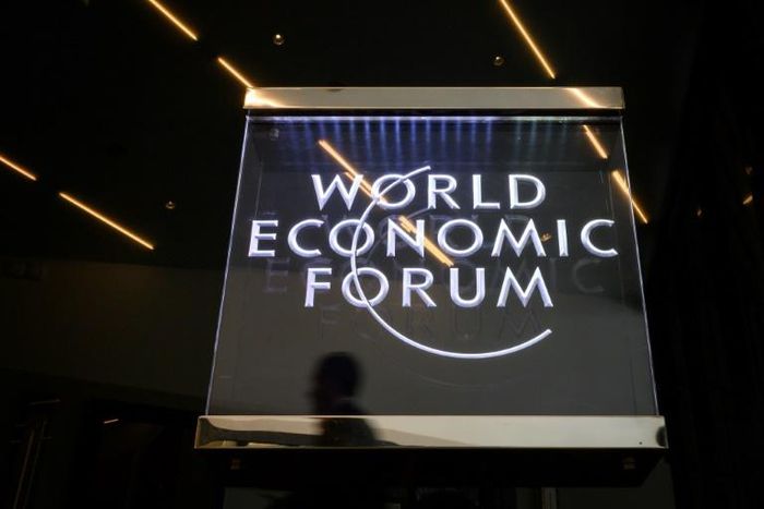 A man walks past a sign of the World Economic Forum (WEF) at the Congress Centre in Davos, eastern Switzerland