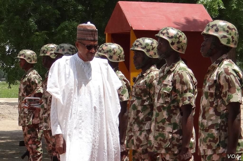 Nigerian President Muhammadu Buhari (in mufty) meets top military officials in Maiduguri as part of a visit to troops on the front lines of the Boko Haram conflict, which claimed another three soldiers' lives earlier this week.