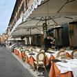 Many of Rome's outdoor restaurants and cafes were either closed Friday night or had free tables overseen by forlorn staff with little to do but chat