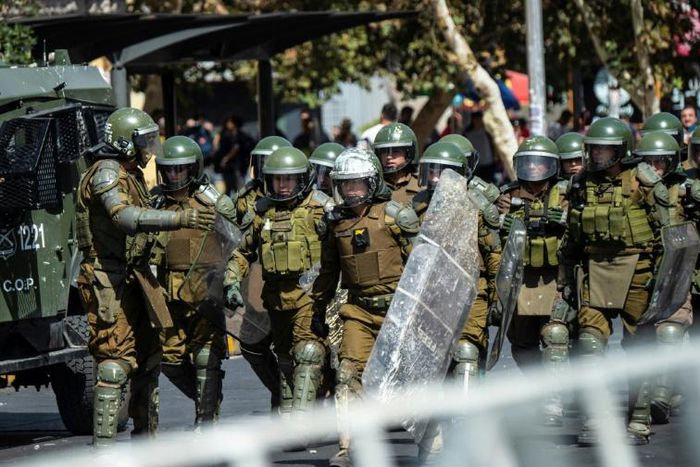 Chilean riot police take position during a protest against President Sebastian Pinera on the second anniversary of his inuguration in Santiago on March 11, 2020.