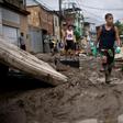 Children walk in the mud following heavy rains during the weekend, in Realengo neighborhood, in the suburbs of Rio de Janeiro, Brazil, on March 2, 2020