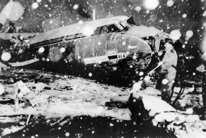 A rescue worker stands next to the debris of the plane carrying Manchester United players that crashed at Munich airport in 1958