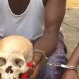 Man nab with human skull/Illustration (Global Patriot Newspapers)