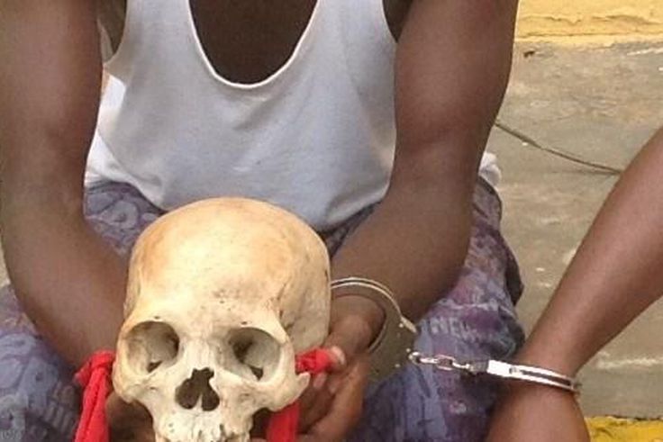 Man nab with human skull/Illustration (Global Patriot Newspapers)