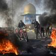 Iraqi protesters block the airport highway in the Shiite shrine city of Najaf, a major draw for foreign pilgrims