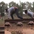 Daring man surprisingly survives after lying on a railway for a speeding train to pass over him (video)