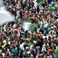 Algerian protesters wave national flags during an anti-government demonstration in the capital Algiers