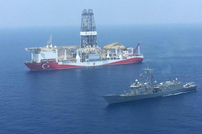 A Turkish navy warship patrols next to Turkey's drilling ship 'Fatih' sent to waters off Cyprus