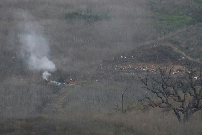 Smoke rises from the site of a helicopter crash in Calabasas, California on January 26, 2020 that killed nine people including NBA legend Kobe Bryant