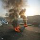 Anti-government protesters tried Monday to block central Baghdad streets with burning tyres