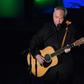 US singer-songwriter John Prine, pictured June 2019, has been hospitalized and intubated due to a "sudden onset of Covid-19 symptoms," according to his family