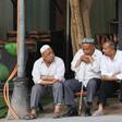 Members of China's Uighur minority outside a coffee bar in the restored old city area of Kashgar, a tourist magnet just a stone's throw from internment camps