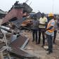 Cross River State Commissioner for Environment, Mr Mfon Bassey (right) during the demolition exercise (NAN)