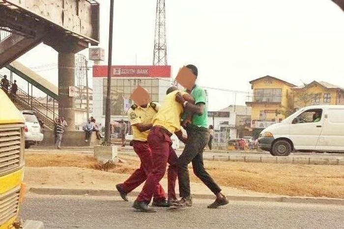 An illustrative photo of LASTMA officers armwrestling a commercial bus driver. [tori]