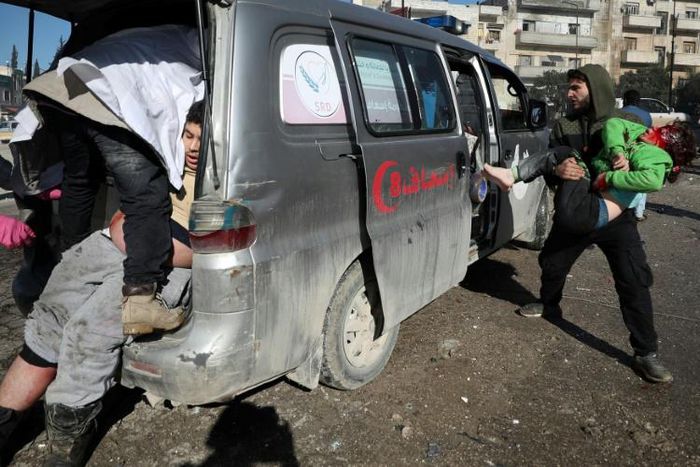 Casualties are loaded into an ambulance  following an air strike by pro-regime forces in the nothwestern Syrian city of Idlib on Saturday