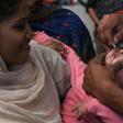 A Pakistani health worker administers polio drops to a child at a railway station during a polio vaccination campaign in Lahore in November 2019