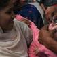 A Pakistani health worker administers polio drops to a child at a railway station during a polio vaccination campaign in Lahore in November 2019