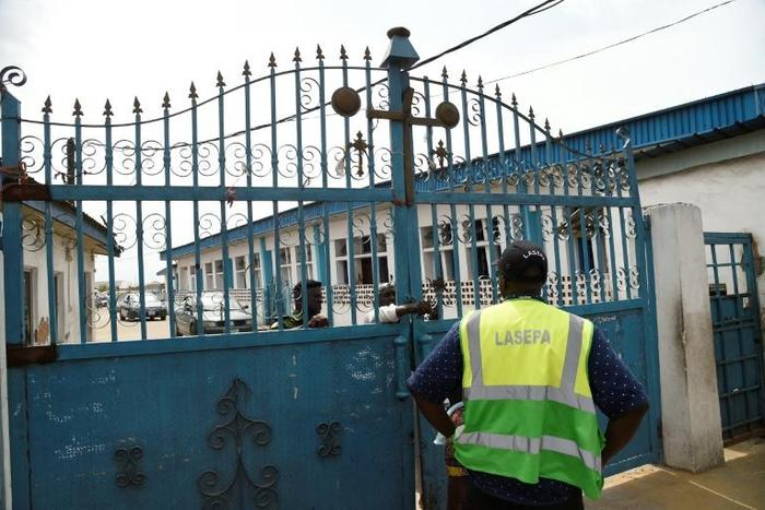 Worshippers clustered at the gate of Makoko's Celestial Church of Christ only to find policemen handing out fliers on the dangers of the virus
