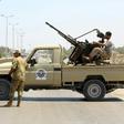 Libyan security forces stand guard at a checkpoint on August 23, 2018
