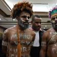 Papuan activists Ambrosius Mulait (left) and Dano Anes Tabuni speak to journalists during their trial in Jakarta