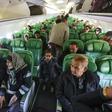 Passengers board and sit inside an aircraft at Mitiga airport, east of the Libyan capital Tripoli
