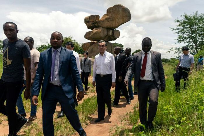 Chinese Foreign Affairs Minister Wang Yi (C) visits the Epworth Balancing Rocks national park in Harare on a visit to Zimbabwe for talks with leaders
