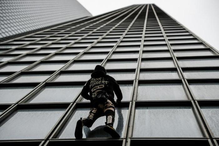 Alain Robert made his own protest to France's planned pension reforms by scaling the Total tower just outside Paris on Monday.