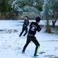 A snowball fight amid the palm trees -- young boys enjoy only the second snowfall in a century to carpet Baghdad and central Iraq