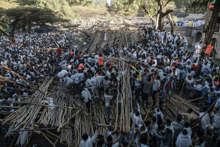 Hundreds had been sitting on a tiered wooden structure for hours when it collapsed