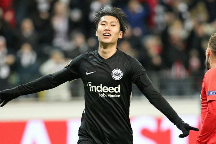 Frankfurt's Japanese midfielder Daichi Kamada celebrates scoring the 2-0 past Salzburg's Austrian goalkeeper Cican Stankovic during the Europa League last 32 first leg football match between Eintracht Frankfurt and Salzburg in Frankfurt am Main on Febr...