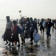 The 17 men, women and children looking exhausted from their ordeal as they climbed down from a wooden boat on to a beach near western Rakhine state's capital, Sittwe