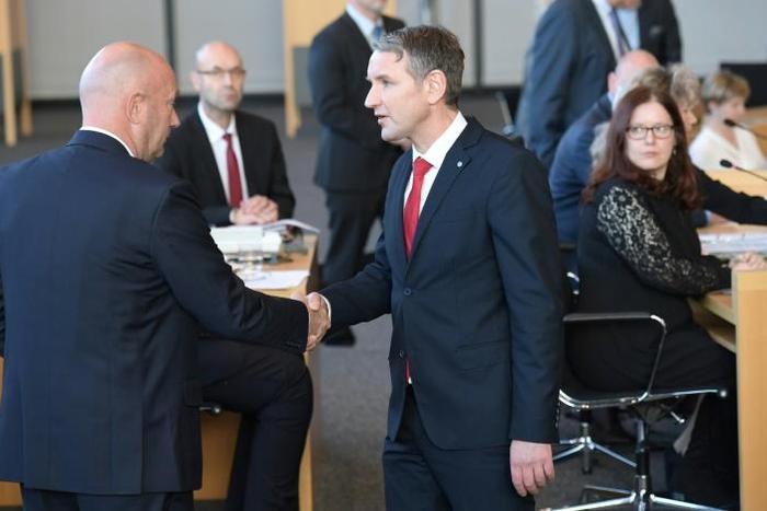 Bjoern Hoecke, chairman of far-right AfD group in the eastern state of Thuringia (R) congratulates Free Democrat Thomas Kemmerich (L), newly elected regional leader, with AfD help