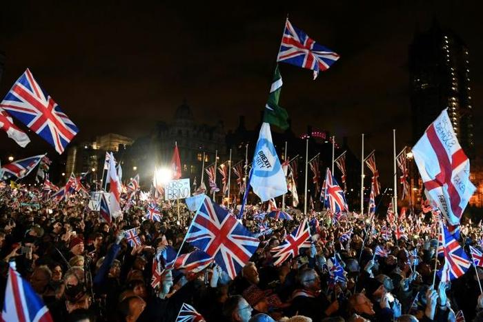 Brexit supporters wave Union flags as they gathered in Parliament Square on January 31, 2020, the day that the UK formally left the European Union