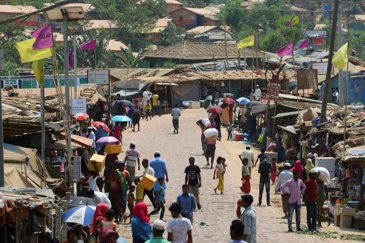 Rohingya refugees gather in a market area of the Kutupalong refugee camp in Bangladesh on March 24, 2020 -- "social distancing" to protect against the coronavirus pandemic is "virtually impossible", an NGO said