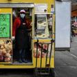 Italians rely on delicacy stores like Gina's at the Porta Palazzo food market in Turin for comfort through the coronavirus emergency