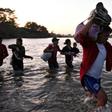 Central American migrants -- mostly Hondurans heading to the US in a caravan -- cross the Suchiate River from Tecun Uman, Guatemala, to Ciudad Hidalgo, Chiapas State, Mexico, on January 23, 2020