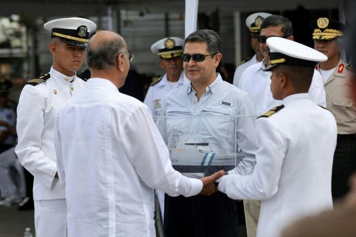 Honduran President Juan Orlando Hernandez (center with sunglasses) takes part in a ceremony marking the arrival of a warship bought from Israel